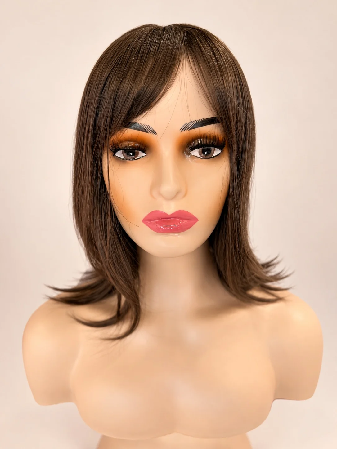 A brunette shoulder-length wig with side-swept bangs